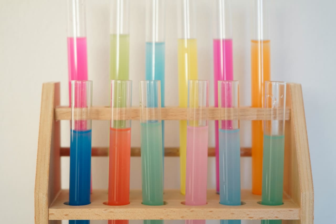 Colour tubes and developer laid out in a salon colour bar