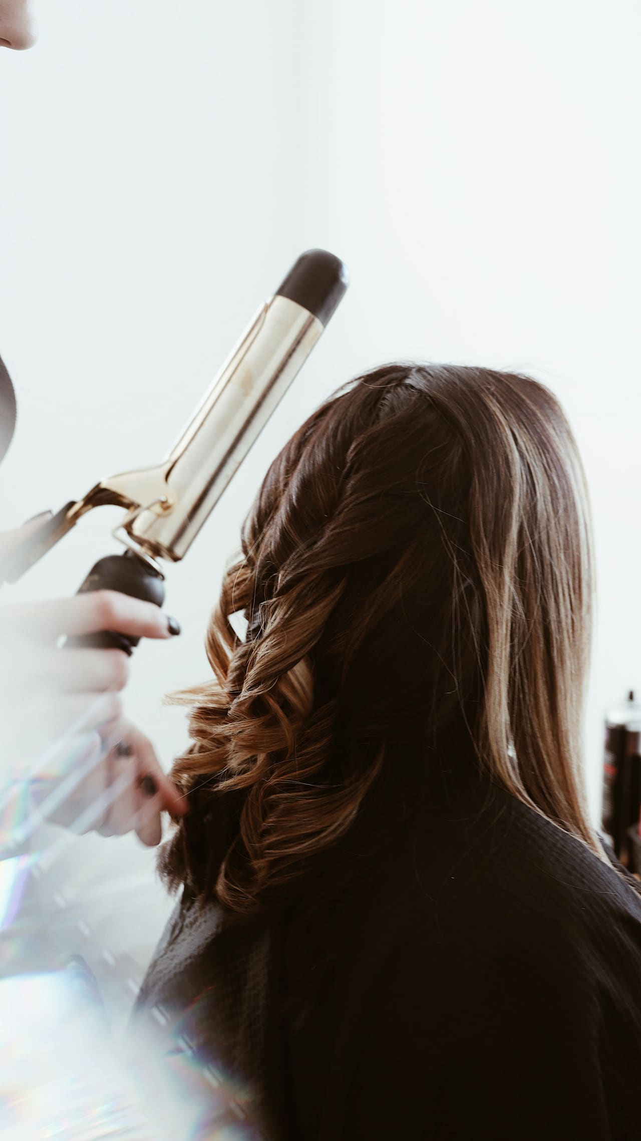 A senior stylist working at a styling chair